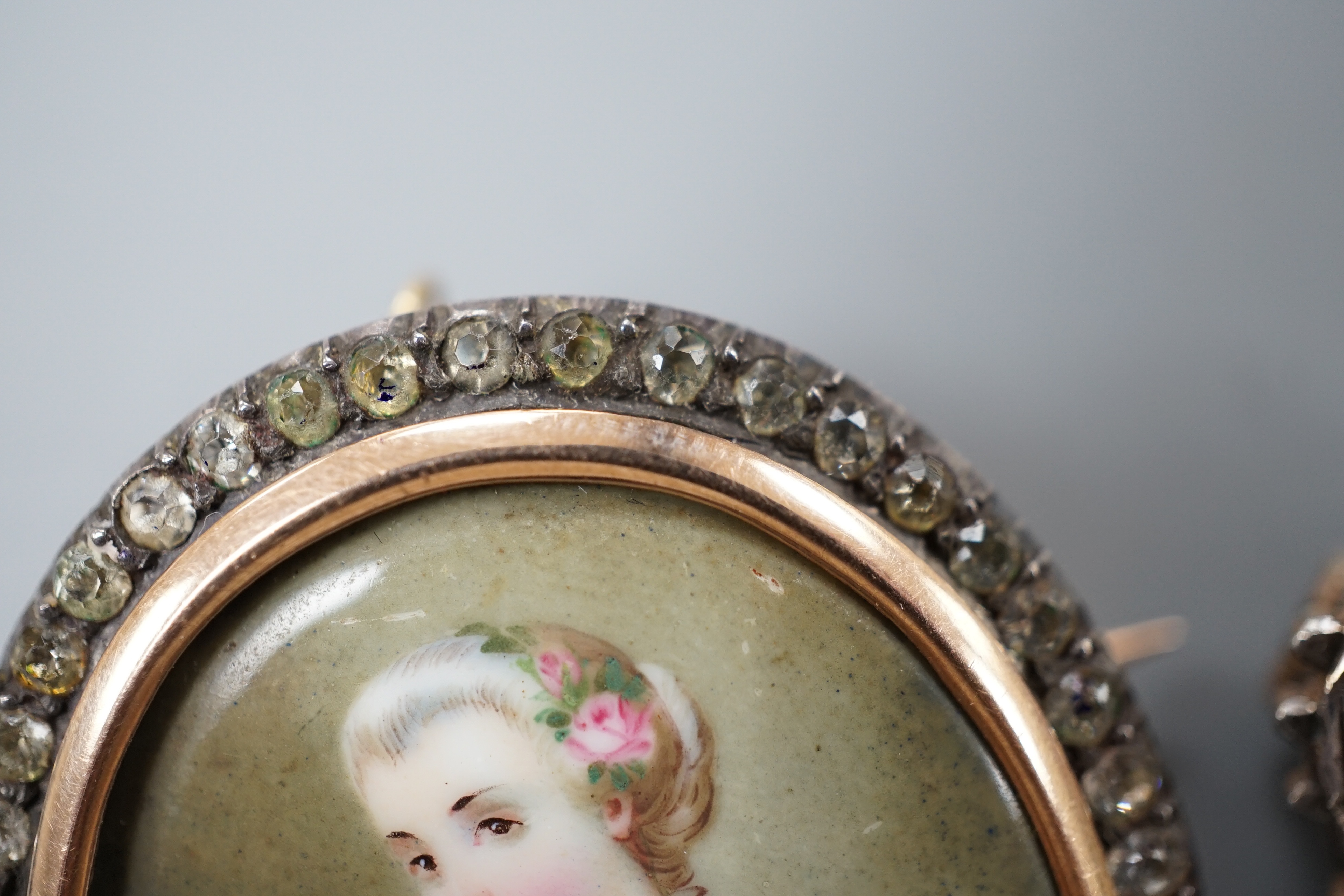 A Victorian yellow and white metal and paste set oval miniature brooch, 41mm and a small circular seed pearl set miniature brooch.